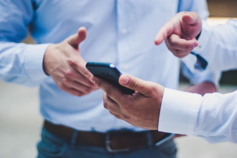 man pointing at phone